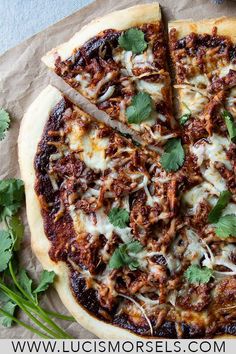 a pizza with several slices missing from it and garnished with cilantro