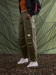 These cargo-style pants are modeled after the US Army M-65 field uniform, one of the most classic military styles to date. The pants include side cargo pockets, drawstring hems, and a double closure waistband for extra security. FEATURES waistband with button and zipper closure drawstring at hem cargo pocket at side seams with hidden snap closure patch pockets on back nylon belt loop detail on wearers left d-ring with alpha red ribbon attached to wearers left back belt loop Gift Guide Women, Cargo Style, Cargo Pocket, Style Pants, Cargo Pant, Red Ribbon, Us Army, Military Fashion, D Ring