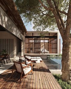 an outdoor deck with chairs and tables next to a pool