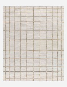 an area rug with squares and lines on the side, in white and beige colors