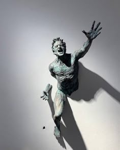 a statue of a man with his hands up in the air and one hand out