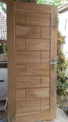 a wooden door with metal handle on it