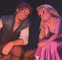 a man and woman dressed as disney characters sitting next to each other