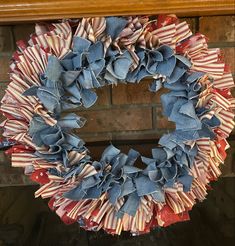 a patriotic wreath with red, white and blue ribbons