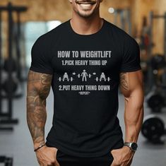 Weightlifting can often feel complicated and intimidating. Break it down into funny and simple terms with the "How to Weightlift Shirt." Express yourself at the gym, and let everyone know you know how to pick heavy thing up and put heavy thing down.  Fit - Classic unisex t-shirt  - Ribbed knit collars to bolster shaping  - Shoulders are tapered for a better fit over time - Dual side seams hold the garment's shape for longer Sizing/Colors - See Images for sizing and color options - For best fit, lay out a favorite shirt at home, measure, and compare to the sizing chart found in the listing images. Material - Fabric blends: Ash - 99% Airlume combed and ring-spun cotton, 1% polyester Heather colors and Solid Black Blend - 52% cotton, 48% polyester, Athletic Heather and Black Heather - 90% cot Powerlifting Shirts, Gym Bro, Weightlifting Shirts, Funny Fitness, Funny Workout, Funny Gym, Weight Lifting Women, Fitness Apparel, Fitness Gifts