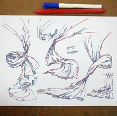 a drawing on paper with red and blue markers next to it