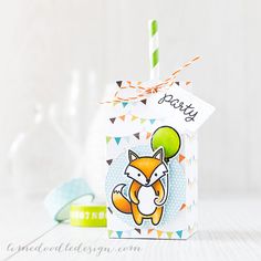 a small gift box with a fox holding a green balloon