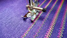 a close up of a machine stitching on fabric