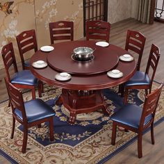 a dining room table with blue chairs around it