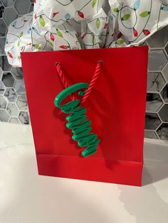 a red gift bag with the word merry written on it