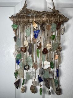 a wind chime hanging from the side of a door with lots of glass beads