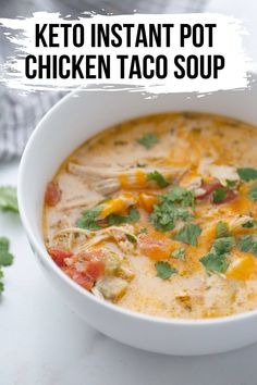 a bowl of chicken enchilada soup with cilantro and parsley