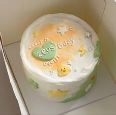 a cake in the shape of a box with baby's first year written on it