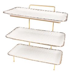 three tiered trays with gold handles and white plates on each side, one holding two