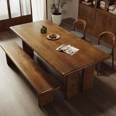 a wooden table with two chairs and a plate of food on it