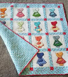 two quilts are laying on the floor next to each other