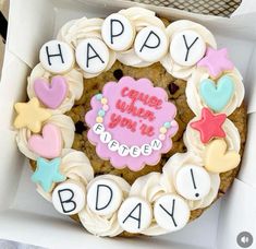 a cupcake decorated with icing in a box that says happy birthday written on it