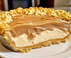 a piece of pie on a white plate with some chocolate frosting in the middle