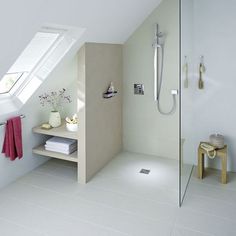 a bathroom with a shower, sink and shelf in it's corner next to the window