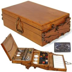 an old wooden box with paint and brushes in it, next to another open case