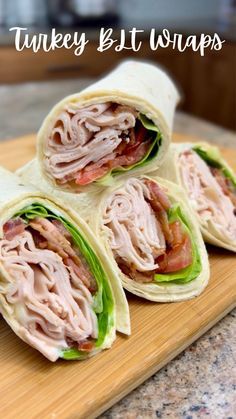 three turkey and lettuce wraps on a cutting board with text overlay that reads turkey & lettuce wraps