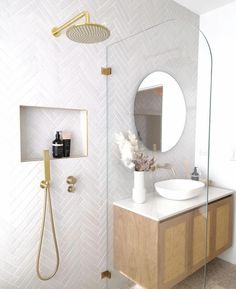 a bathroom with a sink, mirror and shower head in the middle of the room