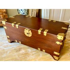 a trunk sitting on top of a hard wood floor