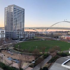 an aerial view of a city park and bridge