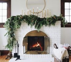 a living room with a fire place and christmas decorations