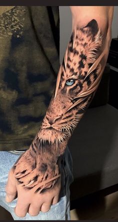 a man's arm with a tiger tattoo on the left side of his arm