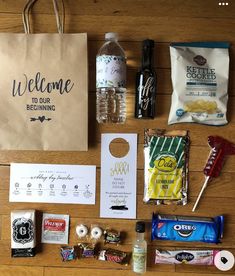 the contents of a bag laid out on top of a wooden table next to some candy