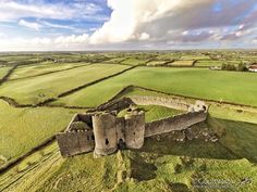 an aerial view of a castle surrounded by green fields