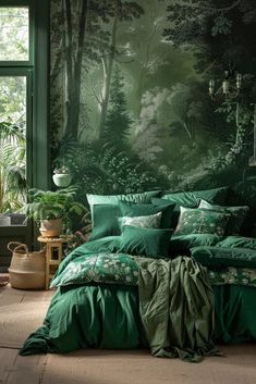 a bed with green sheets and pillows in front of a forest wallpapered bedroom