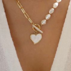 Introducing Our New Elegant 2025 Statement Piece “Heart Of Hearts” Pearl Necklace! This 18” lopsided Fresh Water Pearl & 14k Solid Gold Stainless Steal Heart shaped Charm Necklace encrusted with Flawless Chrystal’s and Clear Sapphire Gemstones On the Toggle Bar Clasp which gives this necklace a unique Uneven Half & Half never before seen Unique Design. This Necklace lets off the most beautiful Bright sparkles with every movement in every light making this necklace the statement piece of the deca Luxury Heart Beads Necklace For Valentine's Day, Luxury Pearl Necklace With Pearl Charm For Festivities, Heart Shaped Jewelry With Toggle Clasp For Anniversary, Valentine's Day Jewelry With Toggle Clasp, Double Heart Necklace, Heart Shaped Pendant Necklace, Pearl Heart, Heart Shape Pendant, Real Pearls