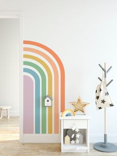 a white room with a rainbow painted on the wall