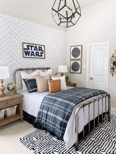 a bed room with a neatly made bed and a star wars poster on the wall