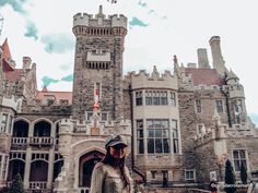 a man standing in front of a castle like building