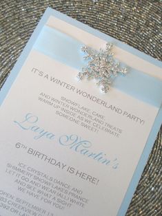 a snowflake on top of a blue and white card with the words it's a winter wonderland party