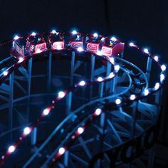 a lit up roller coaster in the dark