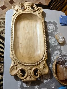 a wooden tray sitting on top of a table next to a bowl and other items