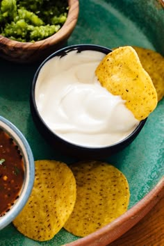 tortilla chips with salsa and guacamole on the side