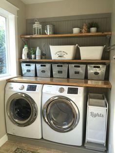 a washer and dryer in a laundry room with shelves above them that hold baskets