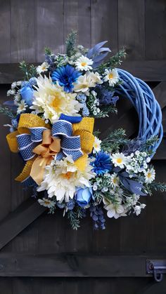 a blue wreath with yellow and white flowers