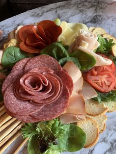 an assortment of meats and vegetables on bread