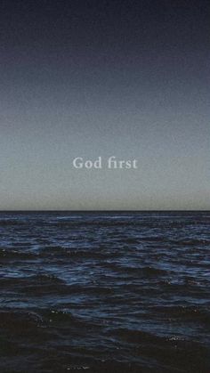 an ocean with the words god first written in white on it's bottom half