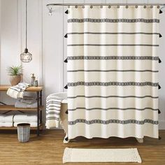 a bathroom with a white shower curtain and black trimmings on the shower curtain