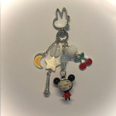 a mickey mouse keychain with charms attached to it