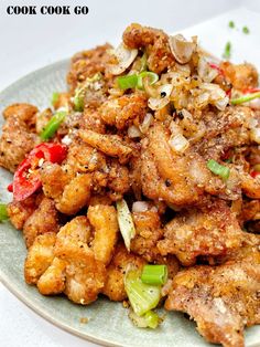 a plate full of fried chicken and vegetables