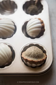 several cupcakes in a muffin tin on a table