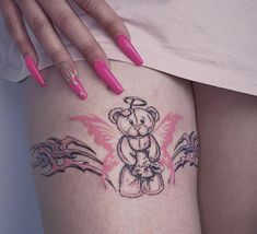 a woman's thigh with a teddy bear tattoo on her left leg and pink nail polish